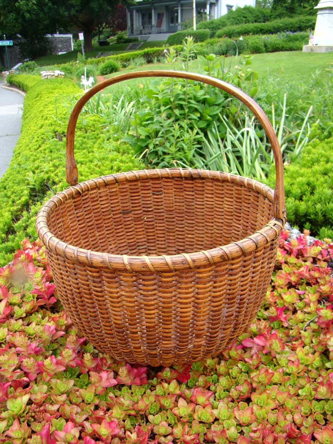 A very fine NANTUCKET 'swing handle' basket made circa 1880.